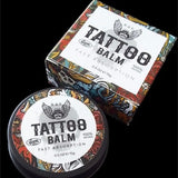 A jar of R&E tattoo aftercare balm with a colorful, artistic label, next to its packaging box.